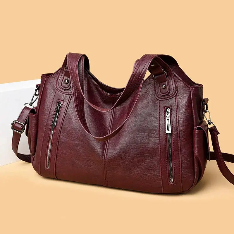 Soft interior compartment burgundy PU leather shoulder bag with dual zipper pockets and detachable strap