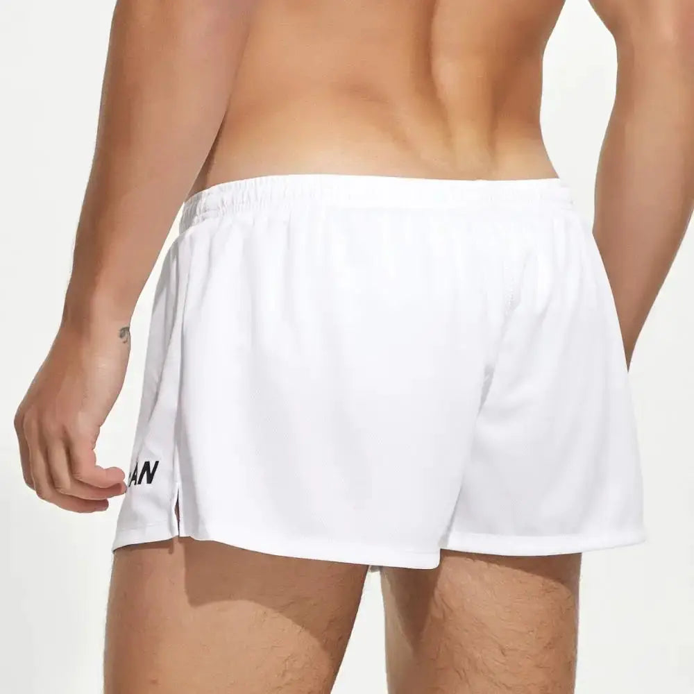 Men's white quick-drying gym shorts with a loose fit and elastic waistband