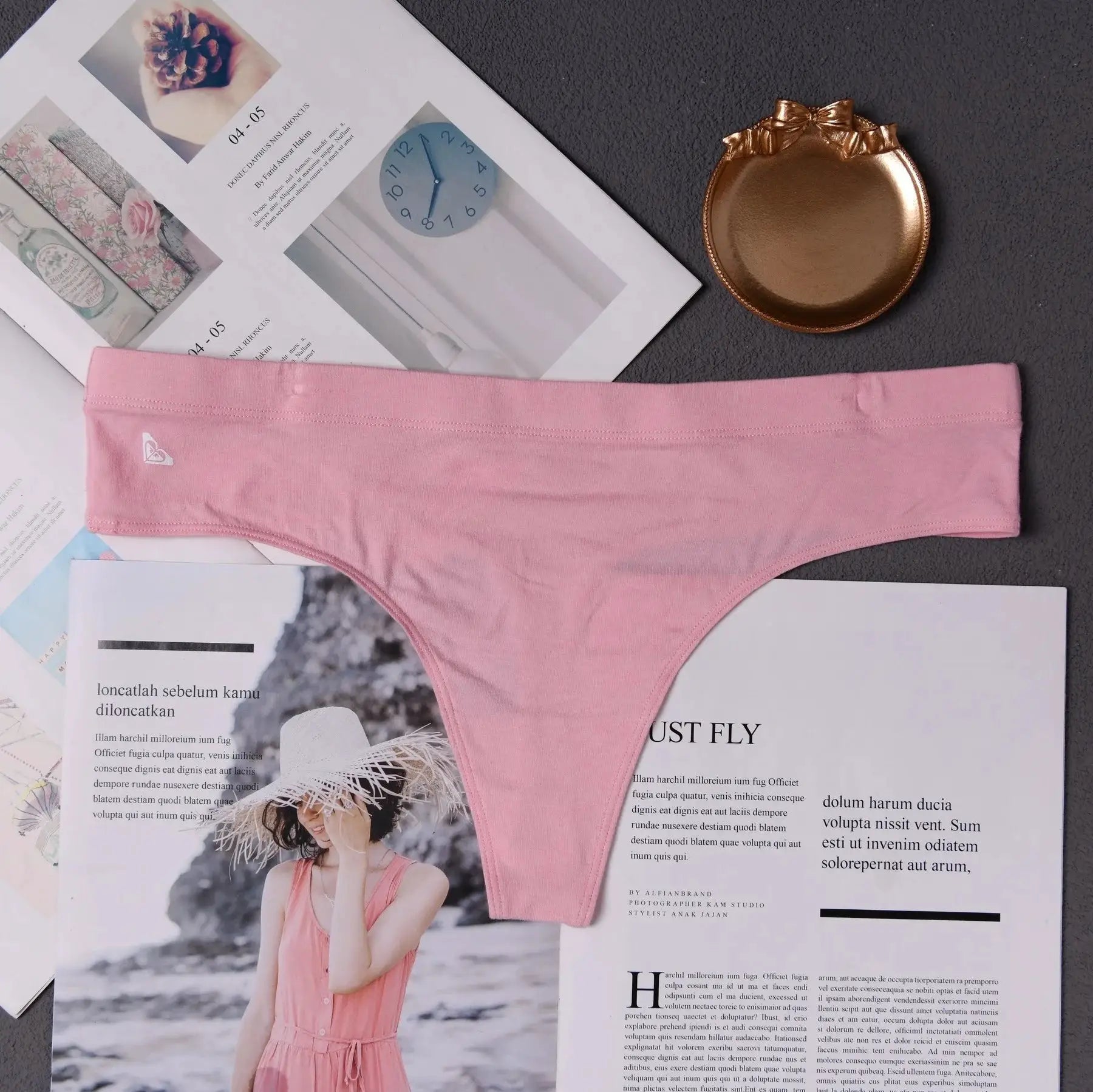 Pink women's seamless thong underwear with invisible seams, minimalist lingerie.