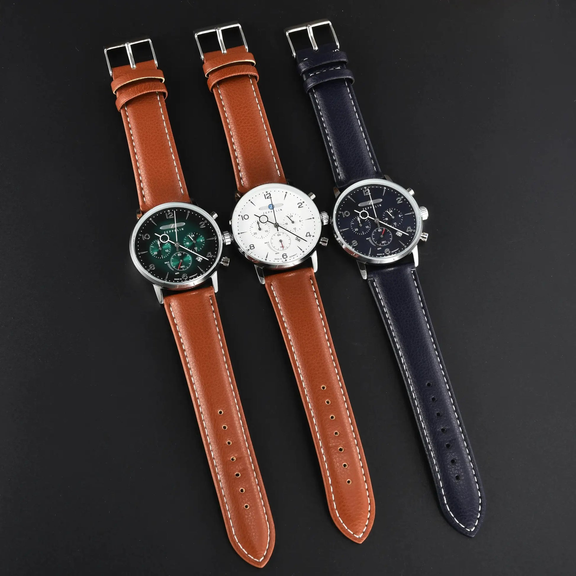 Watch trio: three Zeppelin chronograph watches with brown and navy leather straps.