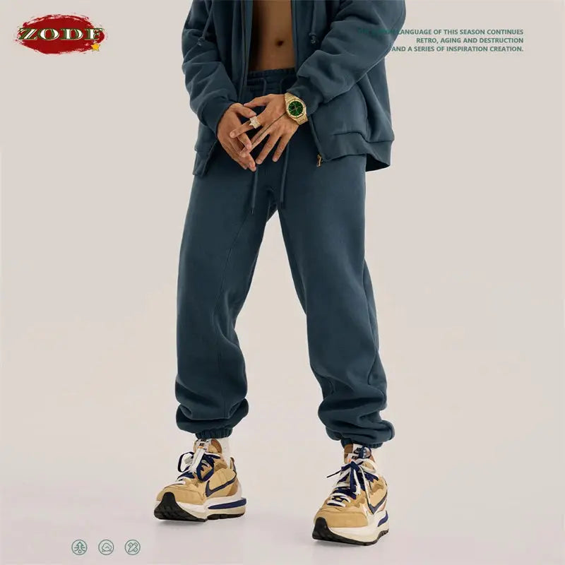 ZODF fleece sweatpants, unisex solid blue joggers with elastic cuffs, shown with beige sneakers
