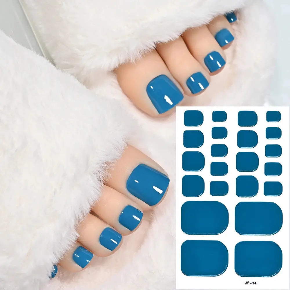 Toenail sticker wraps in blue solid color; full-cover, self-adhesive decals on a sheet for DIY pedicure.