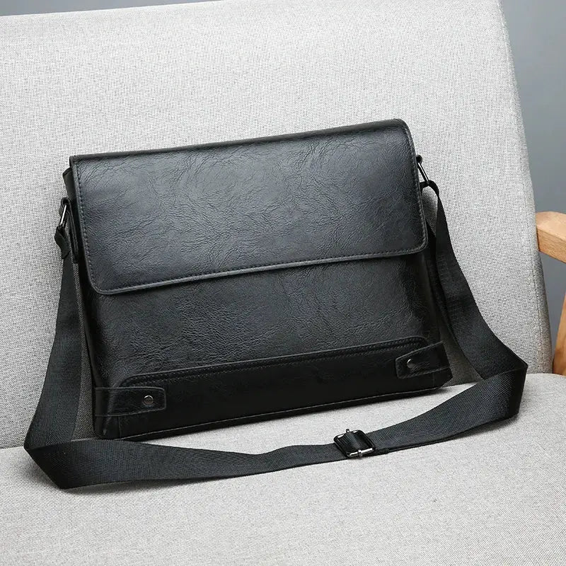 Men's black shoulder bag with crossbody strap; large-capacity faux leather business bag.