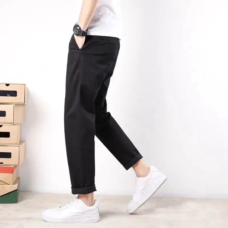HIQOR men's black cotton elastic casual pants, loose fit with cuffed hems.