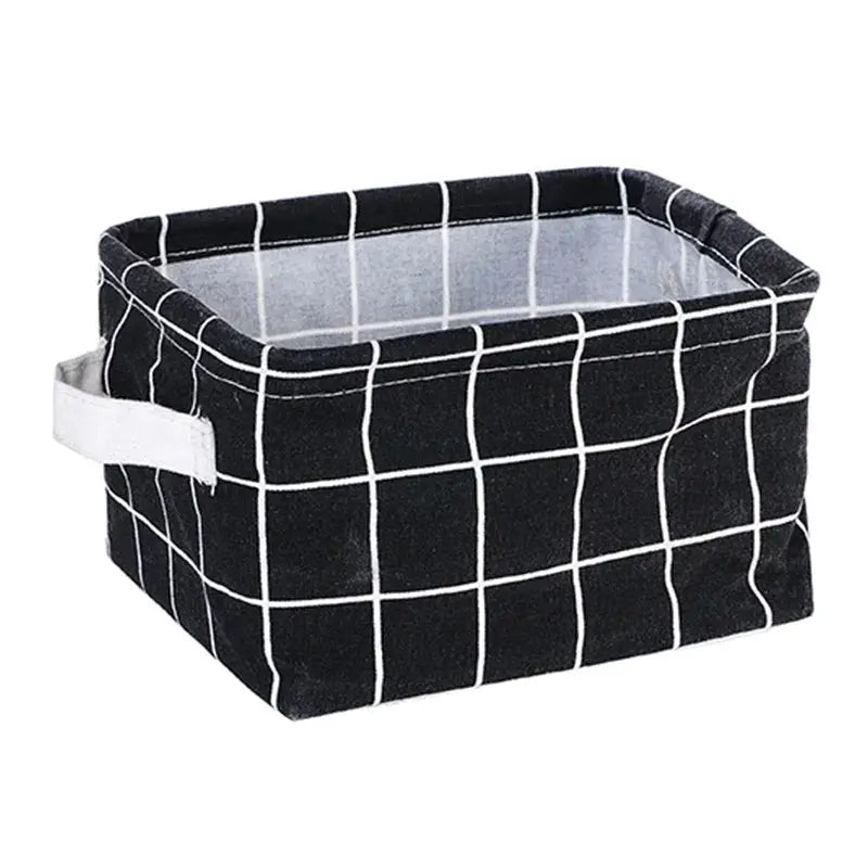 Linen desktop storage basket by Simples Market, black with white grid pattern and a white side handle.