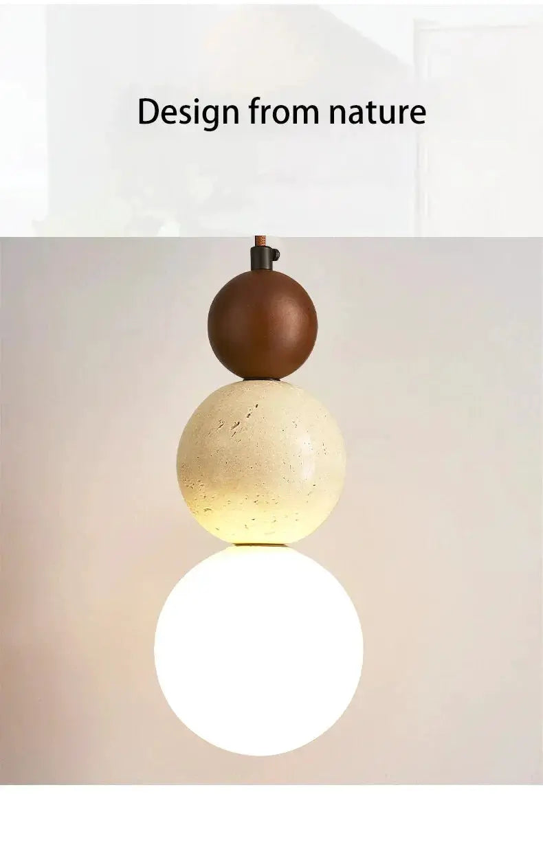 Pendant lamp with three stacked beads: brown wood, cream stone, and glowing white globe.