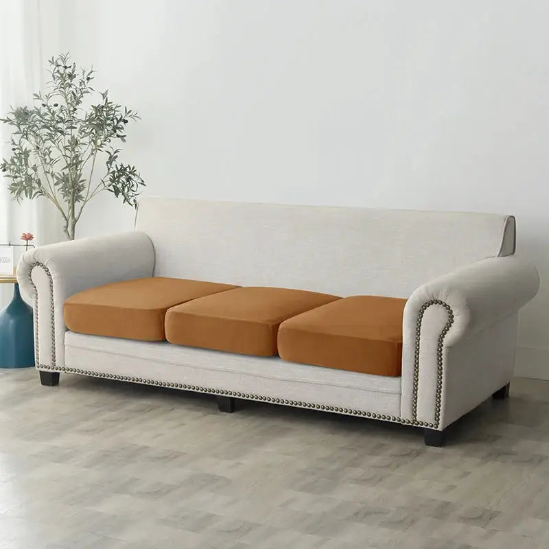 Plush sofa slipcover on light gray sofa with three brown seat cushions