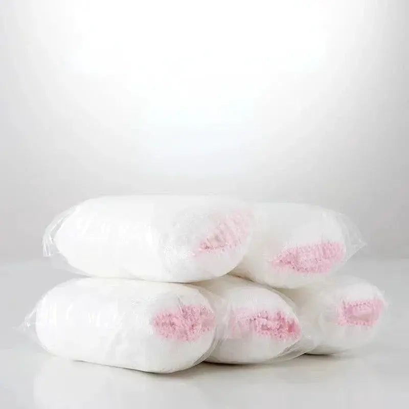 Disposable maternity panties, white with pink lining, sealed in clear plastic packaging
