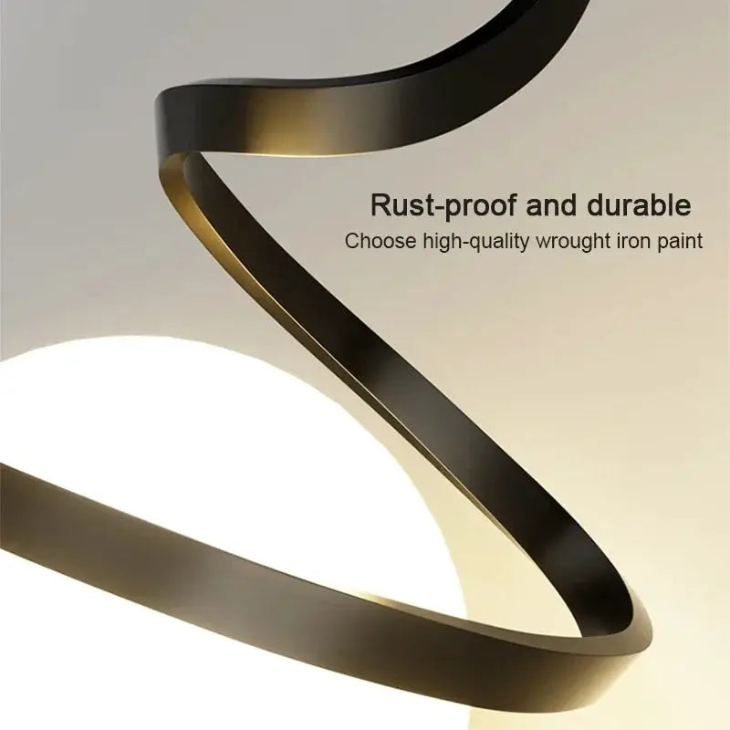Nordic LED pendant light with a sculptural black metal spiral ring for indoor dining and living