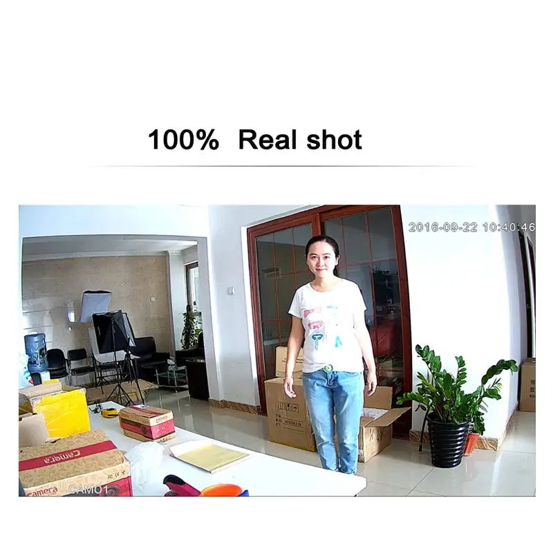 JIENUO 4K AHD CCTV security camera in a room with several boxes and a woman standing