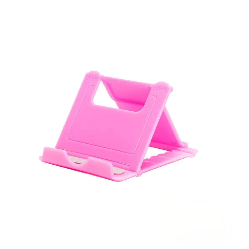 Pink plastic desktop tablet folding stand, portable and adjustable.