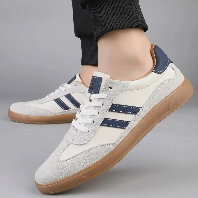 Men's leather sneakers by Simples Market with white-gray upper, navy stripes, and tan gum sole.