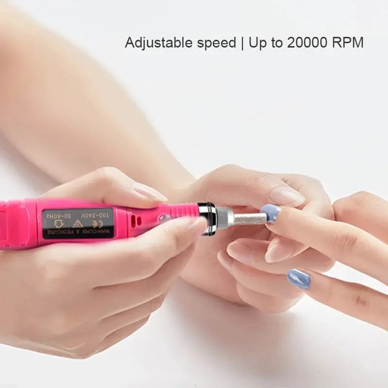 Pink electric nail drill in use on blue-painted nails during gel nail prep