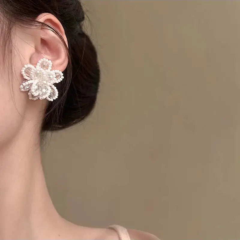 Pearl flower stud earrings with crystal accents; white rose design for women