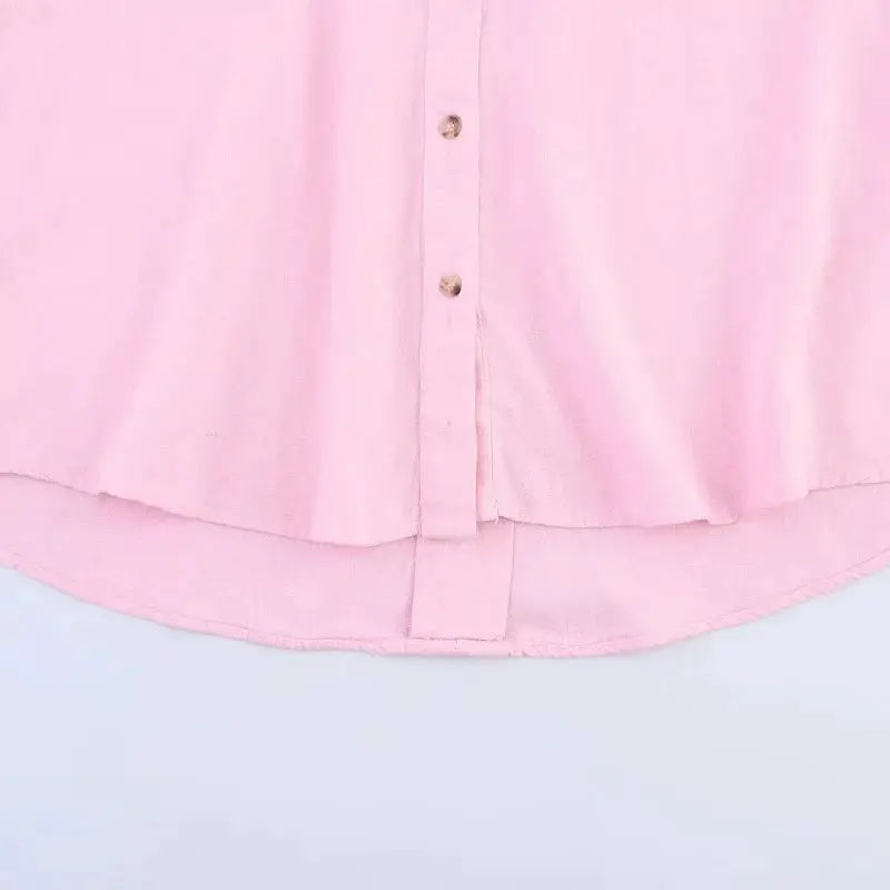 Pink women's button-up shirt with curved hem and visible front buttons