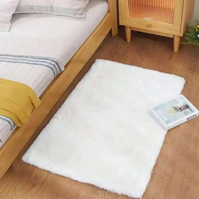 Kids fluffy white shag rug for bedroom; soft, large floor mat beside a bed.