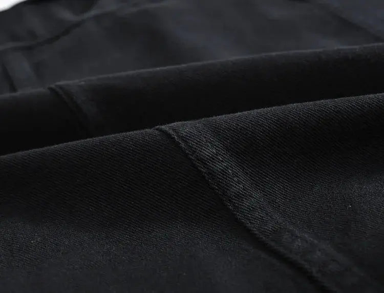 Men's denim jeans vest fabric close-up in black; sleeveless jacket