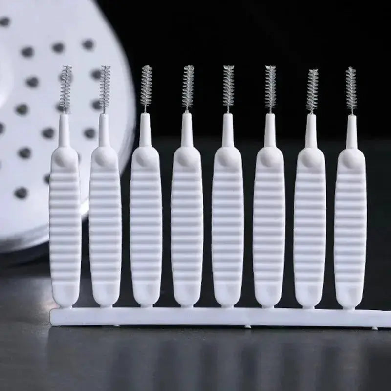 Shower cleaning brush set with white plastic handles and nylon bristles, 9 pieces on a rack