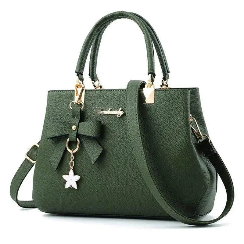 Simples Market green leather shoulder bag with bowknot charm, gold hardware, dual top handles and crossbody strap