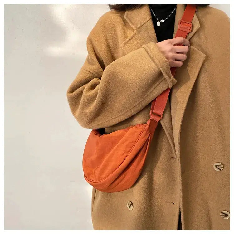 Simples Market casual nylon hobo crossbody bag in orange for women; large-capacity shoulder tote.
