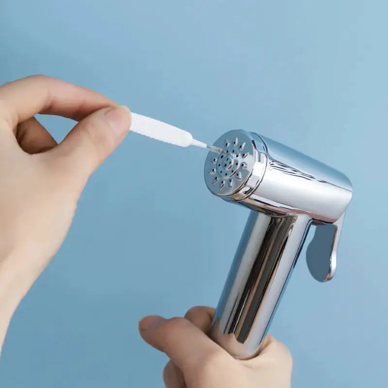 Shower cleaning brush by Simples Market with white micro nylon bristles for nozzle cleaning, chrome handheld head