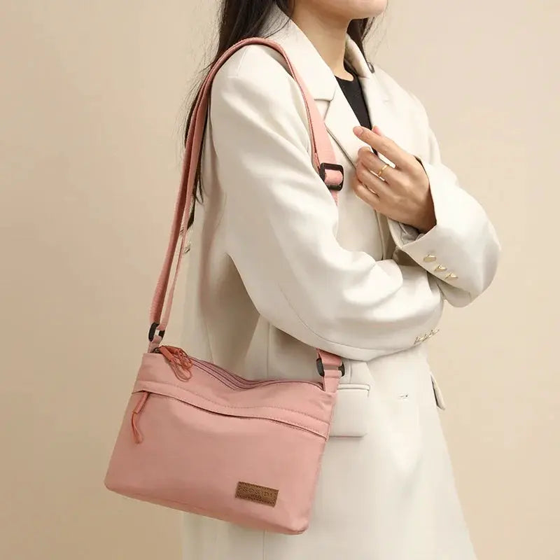 Simples Market pink canvas crossbody bag with 3 main pockets