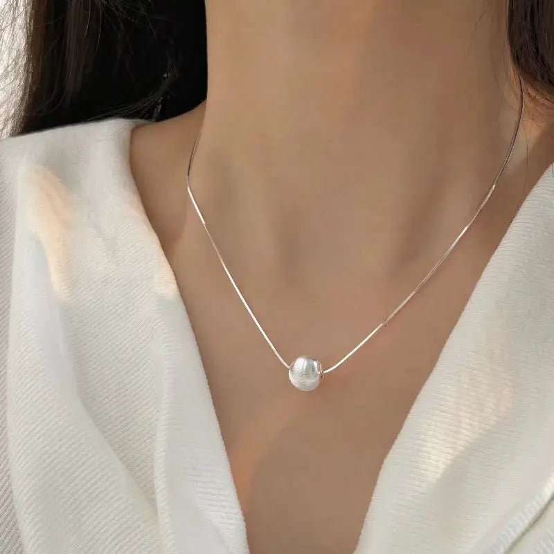 Sterling silver necklace with a simple round bead pendant for women