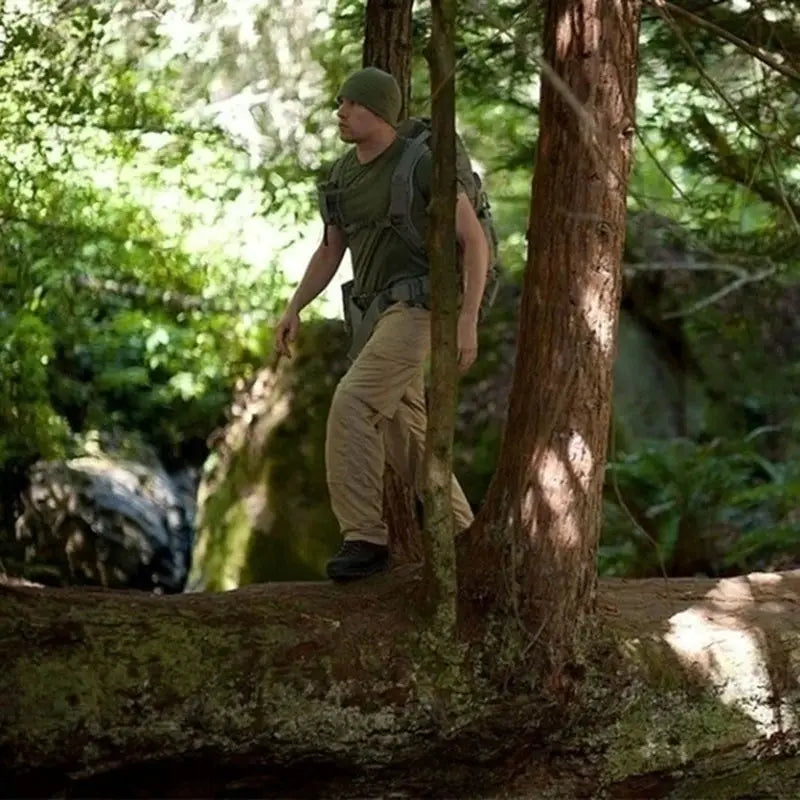 Tactical cargo pants for men in tan camouflage; waterproof, multi-pocket outdoor trousers.