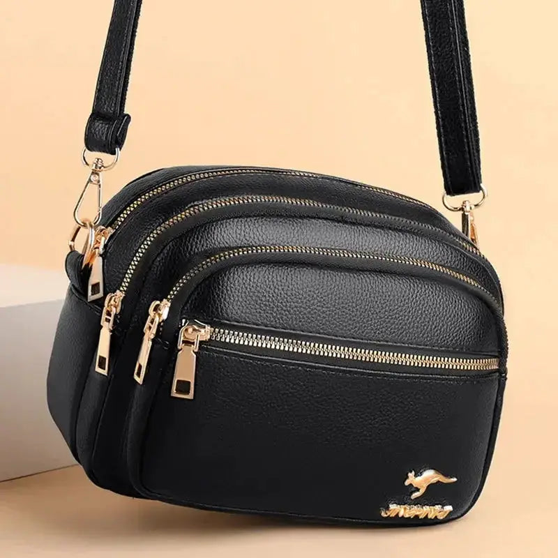 Shoulder bag by Simples Market: black soft leather with three zip pockets and gold hardware.