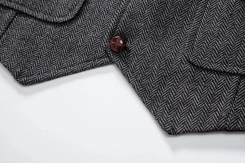 Men's tweed herringbone vest in gray with brown button detail and pockets