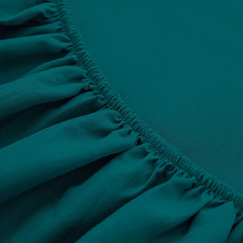 Teal solid color fitted sheet with elastic edge, 100% polyester.