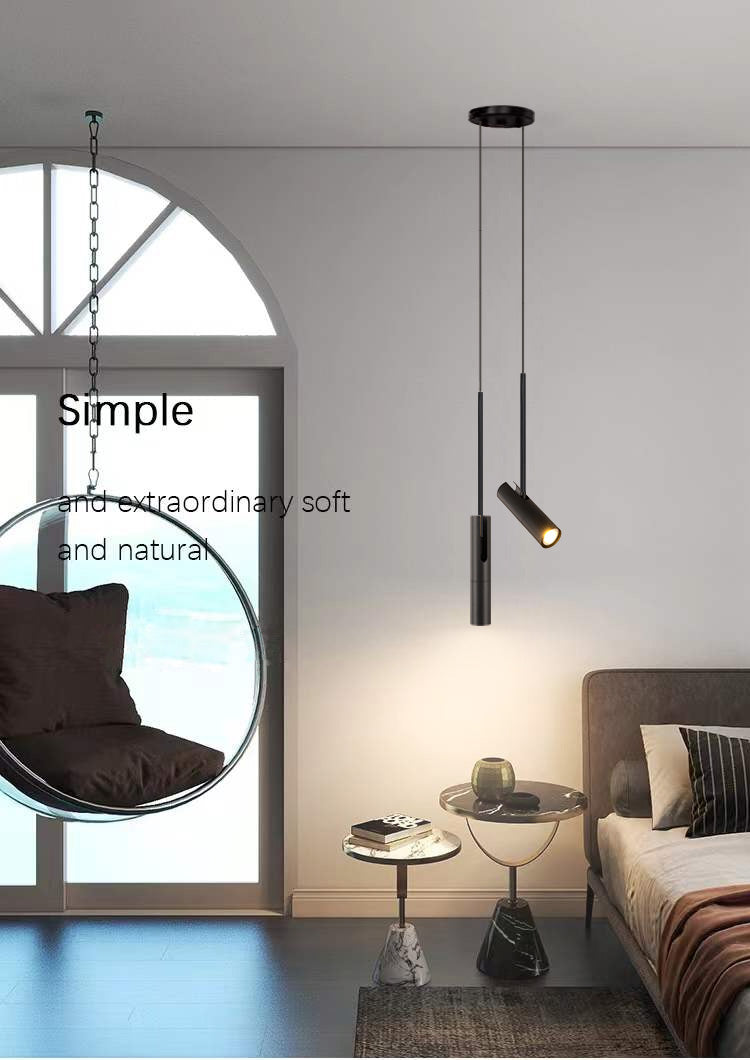 Minimalist LED Hanging Pendant Light Simples Market, twin black cylindrical pendants with warm glow in a modern bedroom