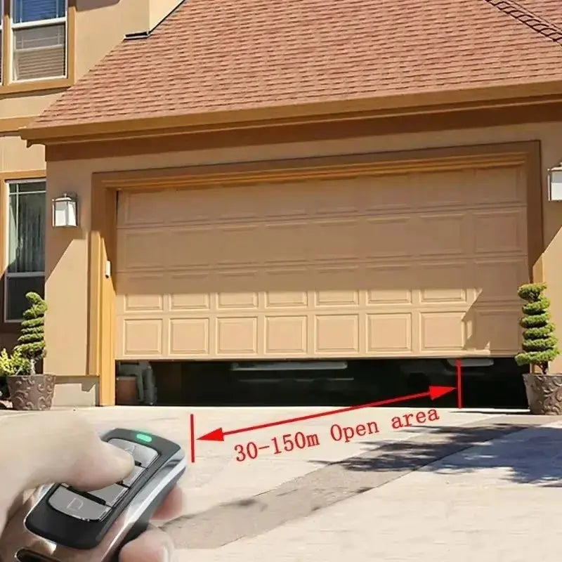 Garage door remote control, 4-in-1 multi-frequency, handheld with green LED in front of an open beige garage door.