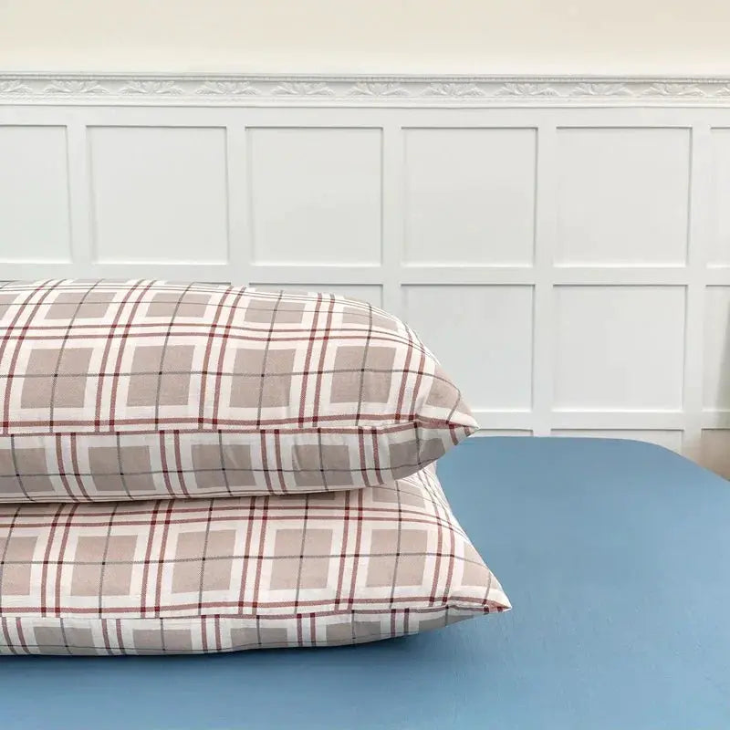 2-pack beige plaid pillowcases on a blue surface, soft fabric