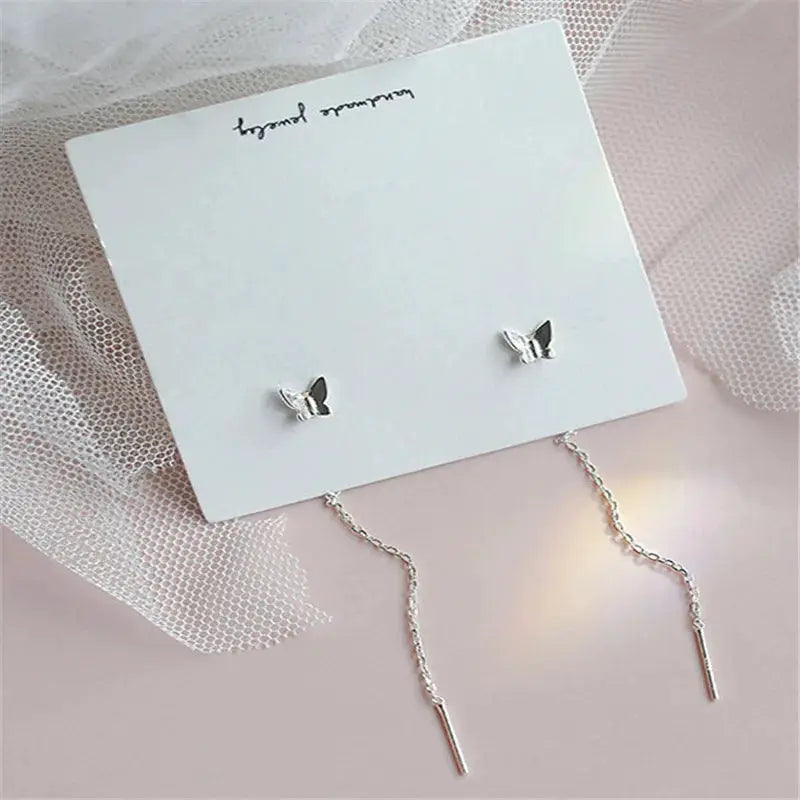 Drop earrings with butterfly stud tops and long silver chain drops, Simples Market pair