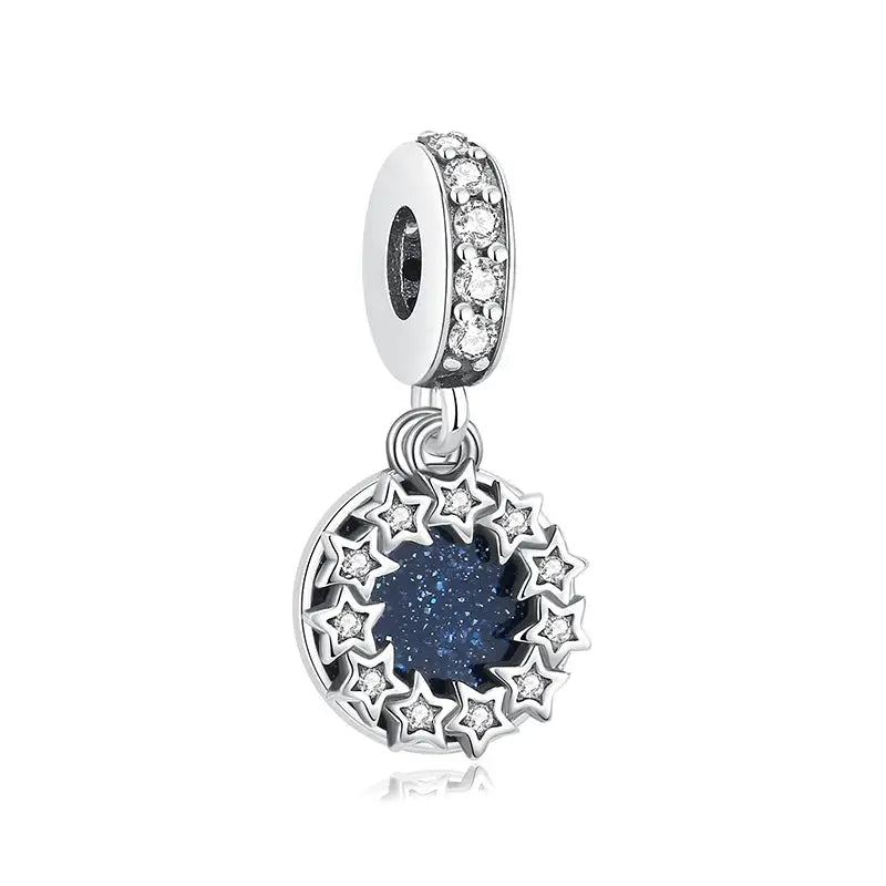 Sterling silver charm pendant with a blue starry center encircled by silver star accents set with zircon stones