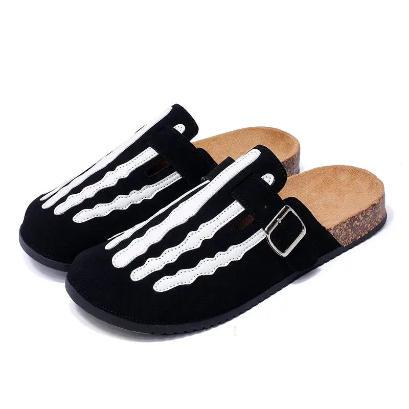 Cork footbed clogs in black suede with white wavy straps and buckle