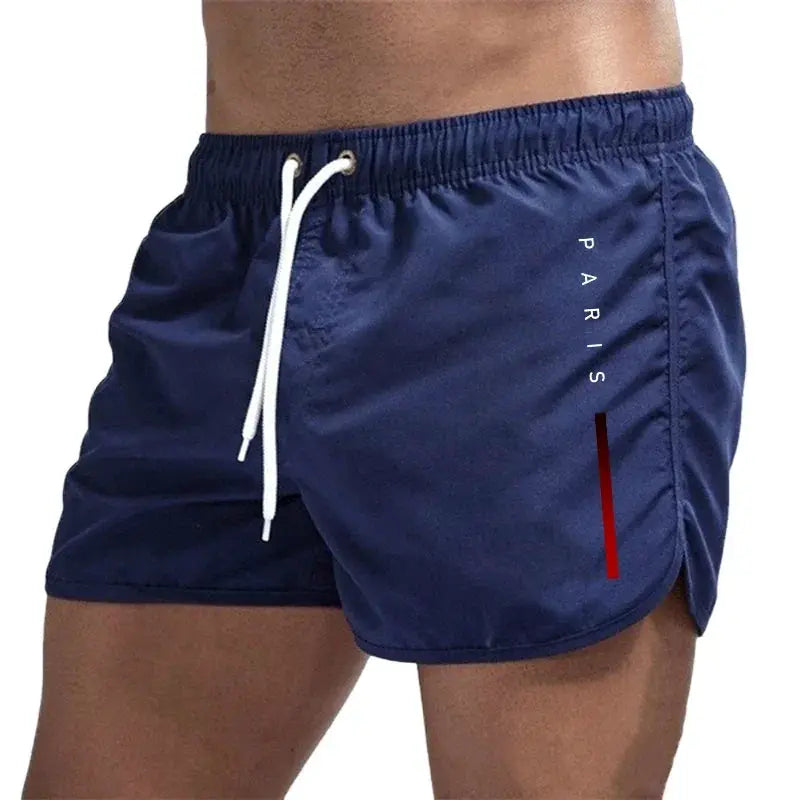 Men's board shorts by Simples Market in navy blue with white drawstring, Paris logo, and red accent stripe