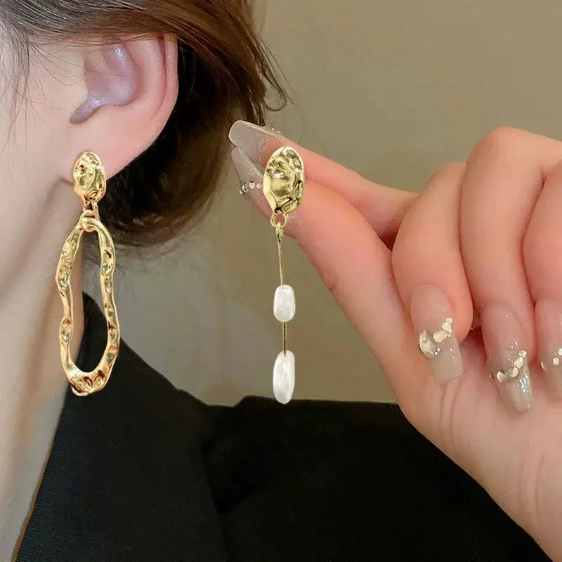 Gold irregular long pearl drop earrings; two styles shown with a textured hollow hoop and pearl-chain drops