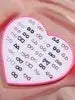 36-pair mini resin stud earrings on a pink heart tray featuring snowflake, cat, and butterfly designs