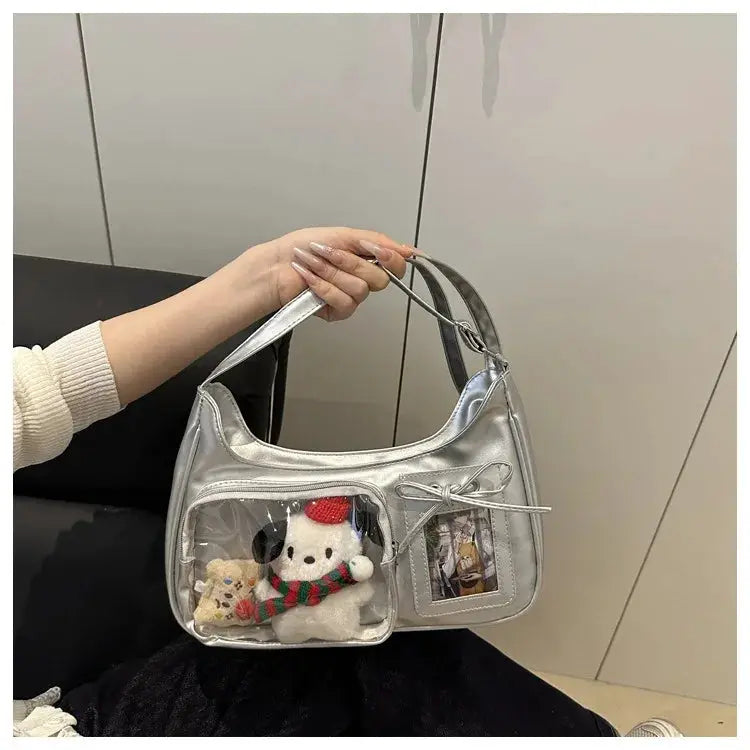 Y2k Harajuku transparent ita bag in metallic silver with a clear front pocket showing two plush toys inside
