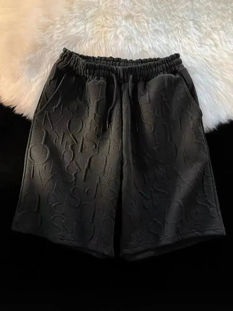 Simples Market black waffle shorts with elastic waist, loose fit, embossed letter pattern