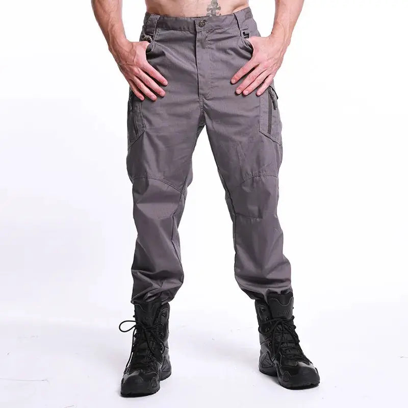Men's military tactical cargo pants in grey with multiple pockets, waterproof and wear-resistant outdoor trousers.