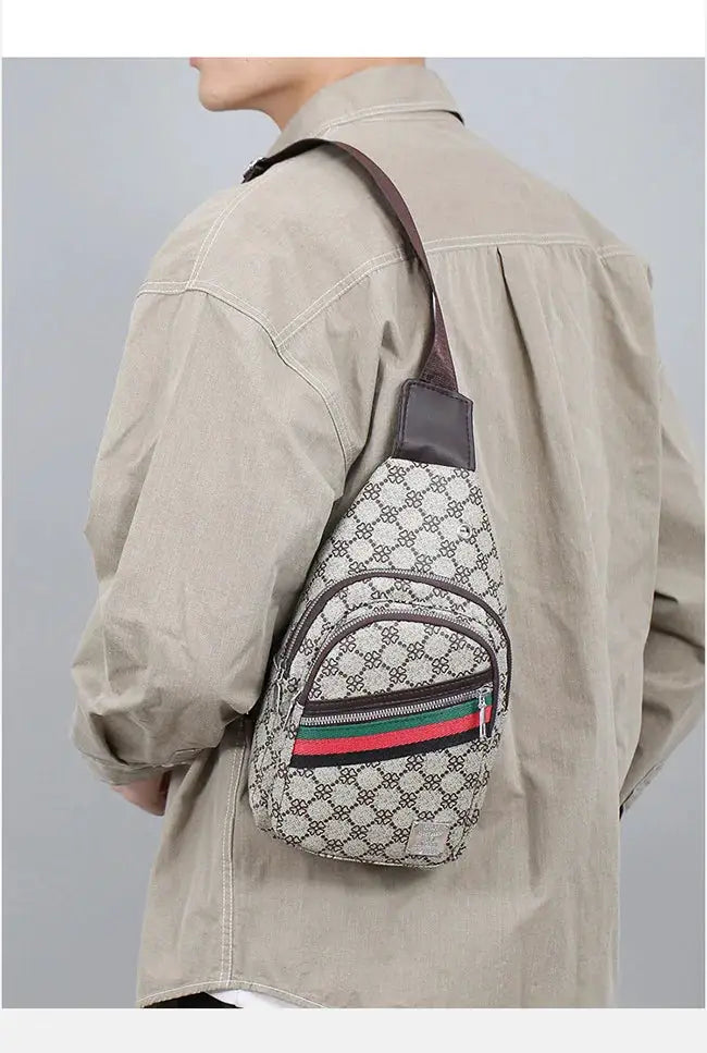 Men's beige patterned crossbody messenger bag with brown strap and front zip pocket featuring a green-red-green stripe.