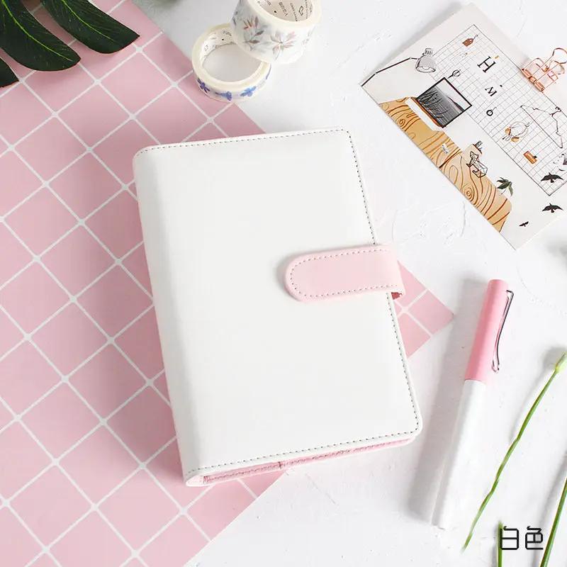 White leather refillable notebook cover with pink strap closure
