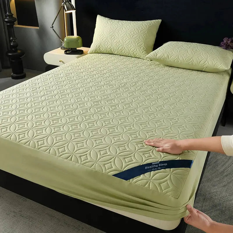 Simples Market quilted pale-yellow fitted mattress protector with 30cm deep pocket on bed with matching pillows