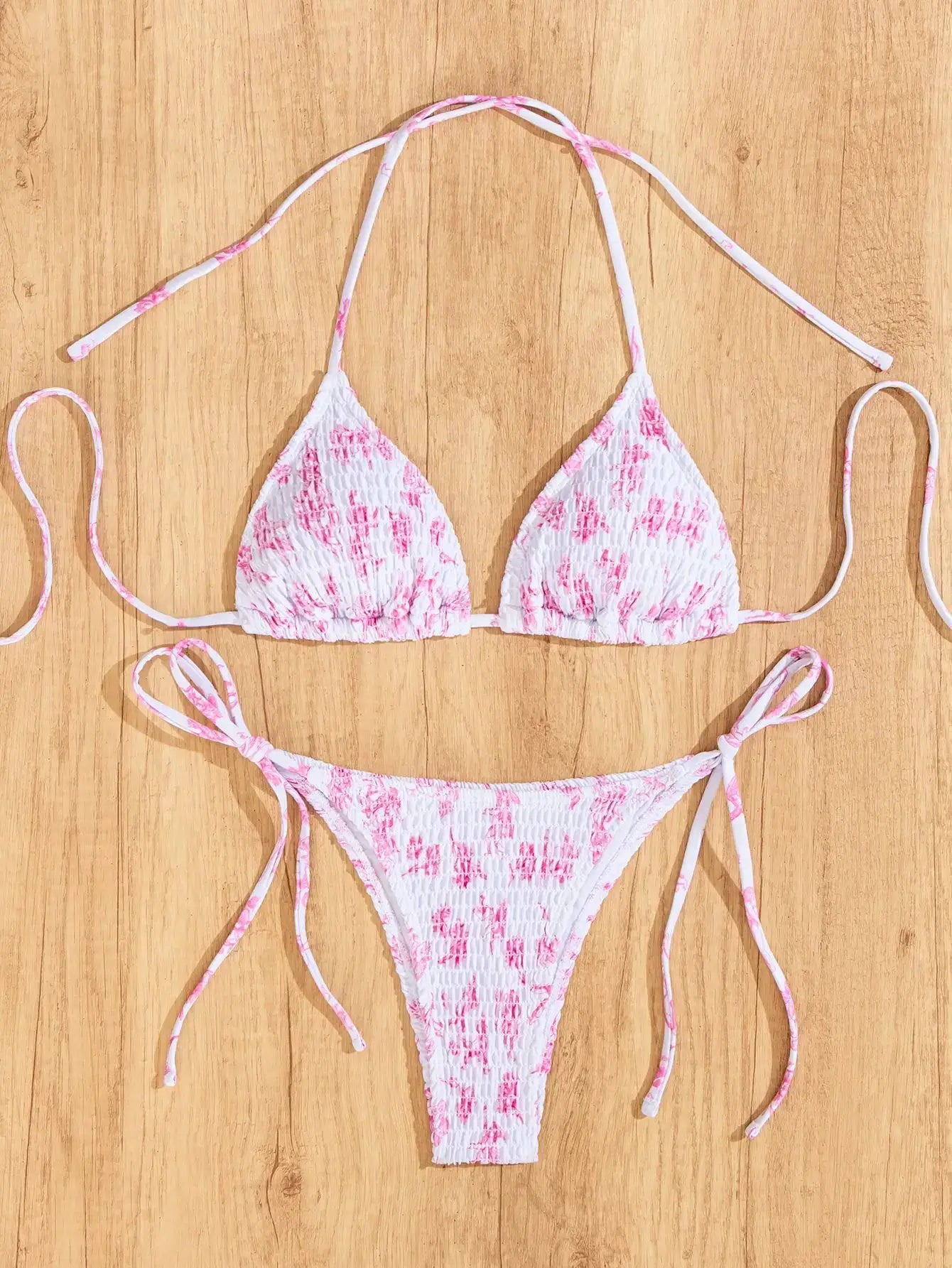 Triangle bikini set in white with pink floral print, string-tie top and Brazilian-cut bottoms