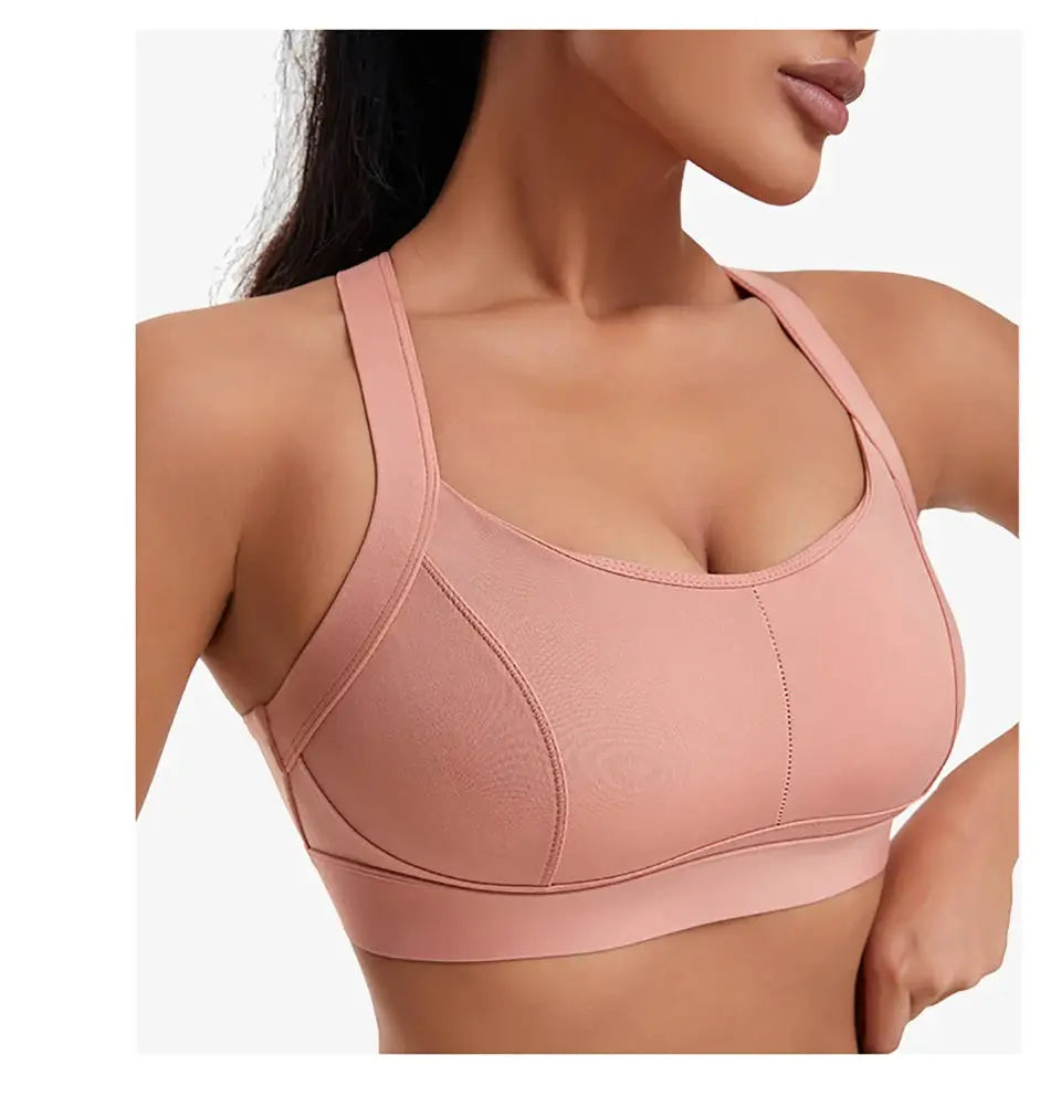 Women's pink high-impact sports bra with padded cups and wide straps for workout comfort