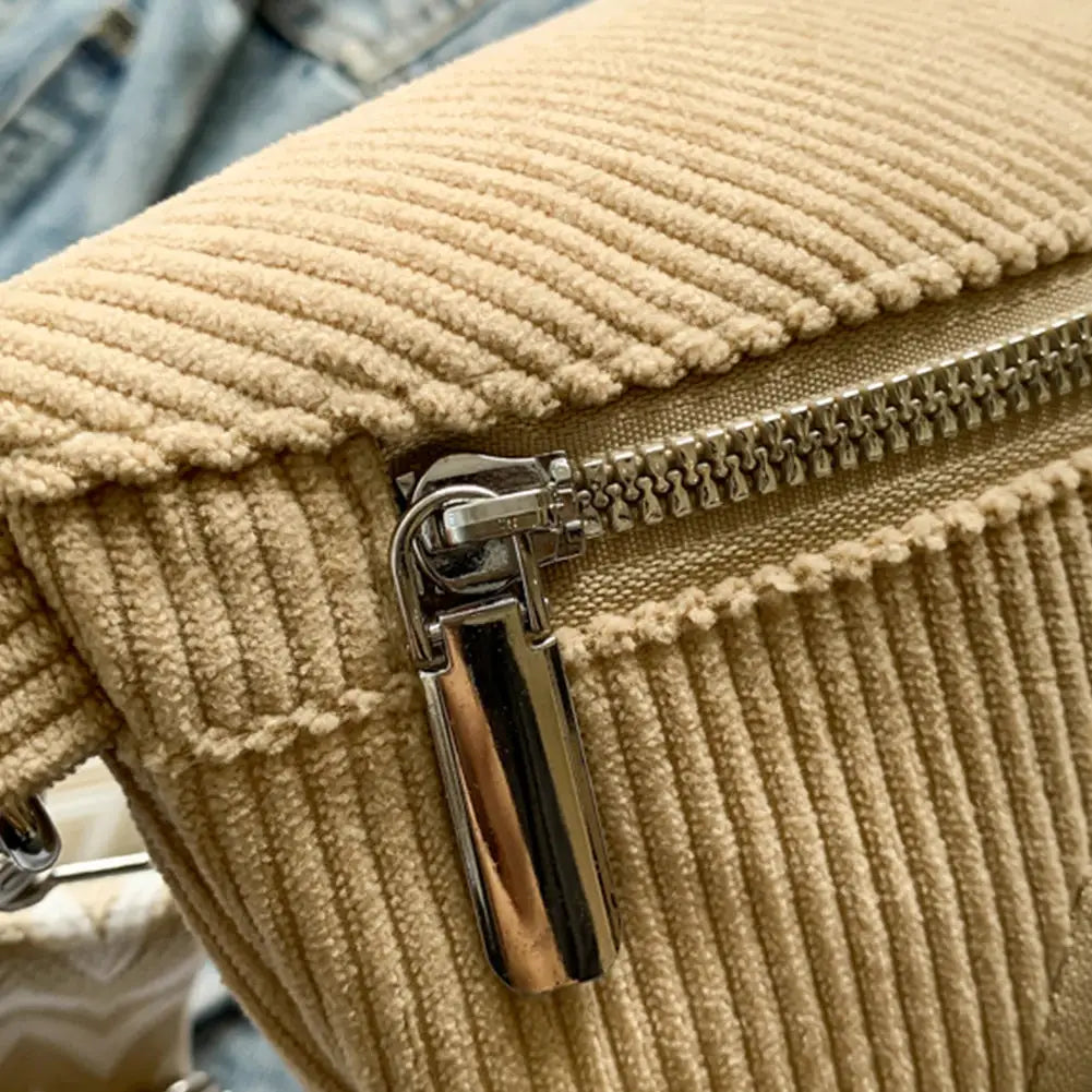 Corduroy chest bag in beige with a silver zipper and metal hardware.