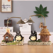 Totoro LED desk lamp set by Simples Market with two bulbs, two Totoro figures, cottages, and stone base decor.